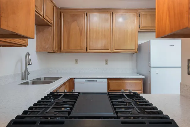 a view of a small space with wooden floor and a hallway