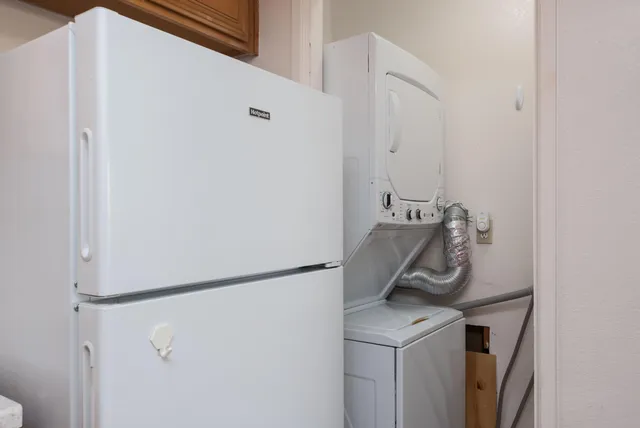 an empty room with chandelier fan