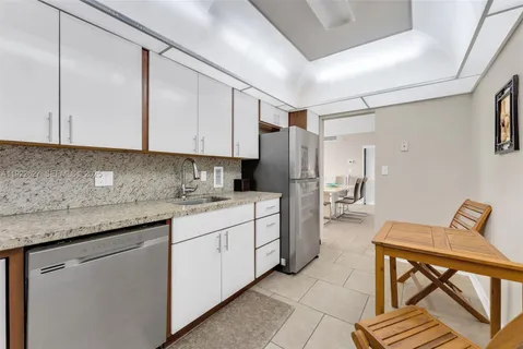 a kitchen with stainless steel appliances granite countertop a refrigerator sink and cabinets