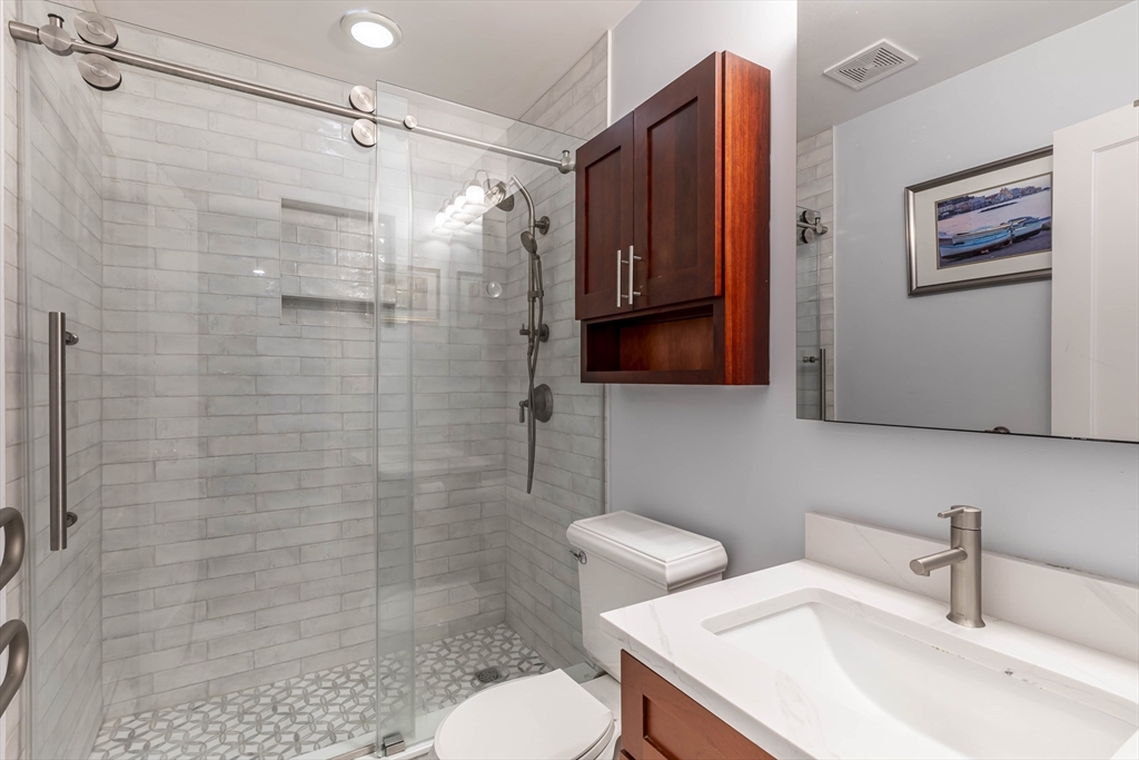 52 Cooper Street, Unit 2 Boston, MA 02113 - Photo 12 of 15 a bathroom with a sink toilet and shower