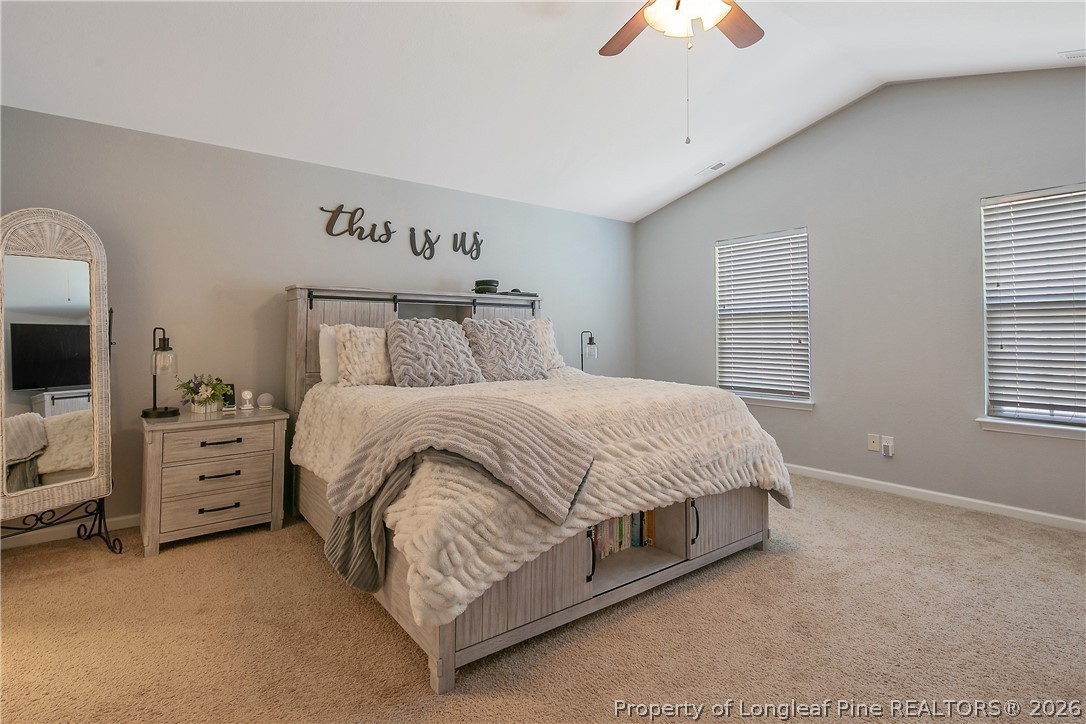 340 Battery Way Bunnlevel, NC 28323 - Photo 23 of 50 a spacious bedroom with a bed and a chandelier
