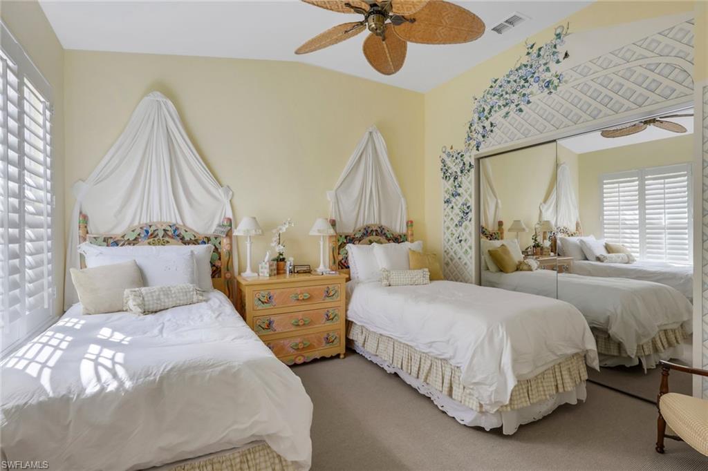 10801 Crooked River Road, Unit 203 Estero, FL 34135 - Photo 19 of 27 a bedroom with double bed and a chandelier