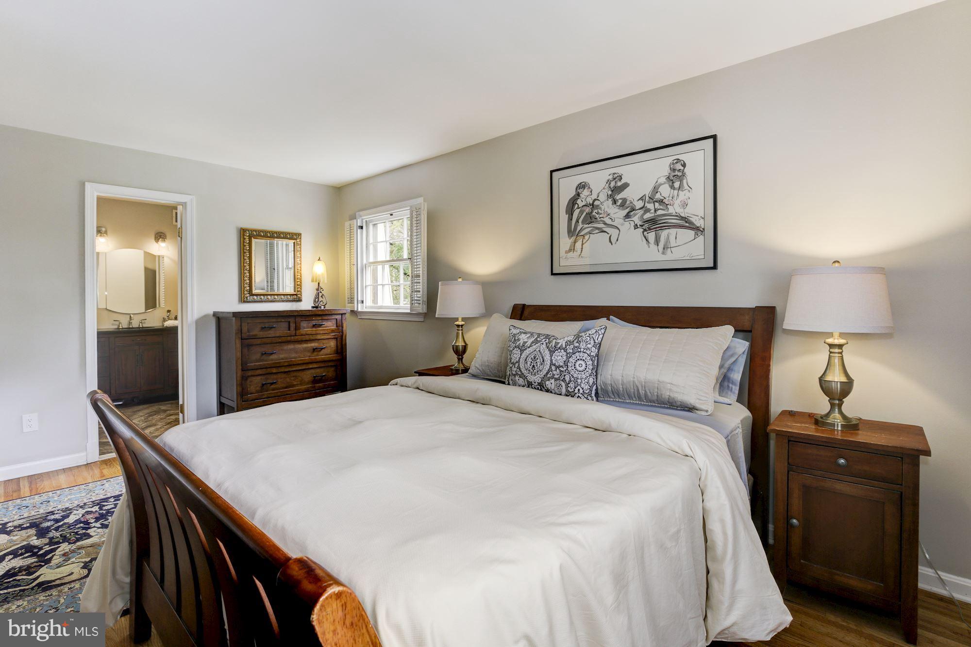 4801 Little Falls Road Arlington, VA 22207 - Photo 12 of 28 a bed room with a bed and a lamp