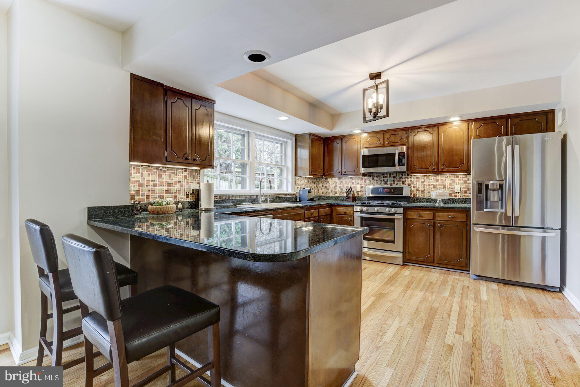 4801 Little Falls Road Arlington, VA 22207 - Photo 9 of 28 a kitchen with granite countertop a sink appliances cabinets and counter space