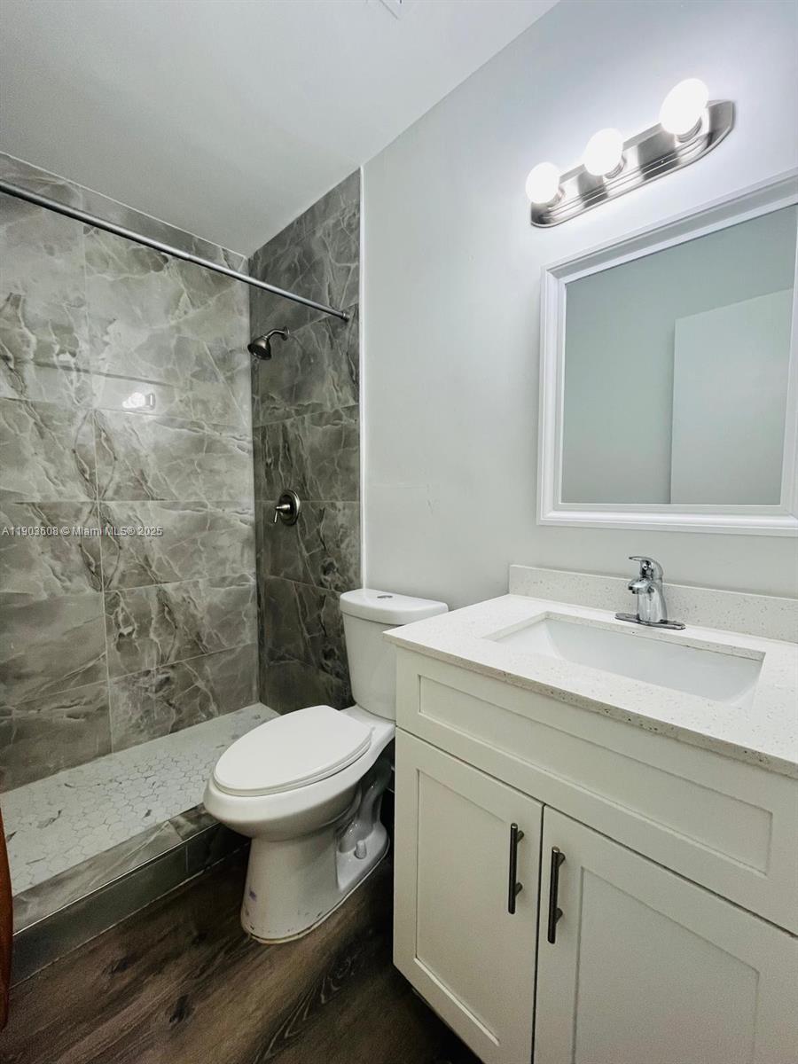 a bathroom with a sink toilet and shower