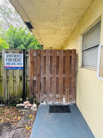 a wooden fence with a bench in patio