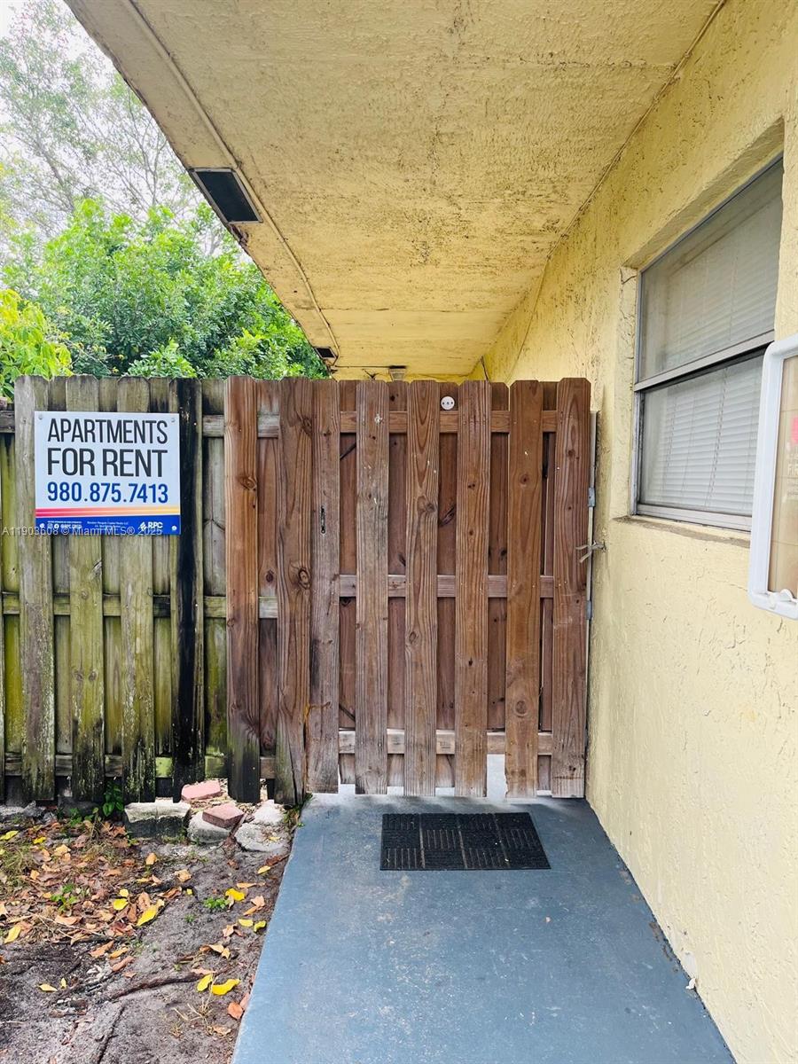 7740 Southwest 10th Street, Unit 1 North Lauderdale, FL 33068 - Photo 14 of 24 a wooden fence with a bench in patio