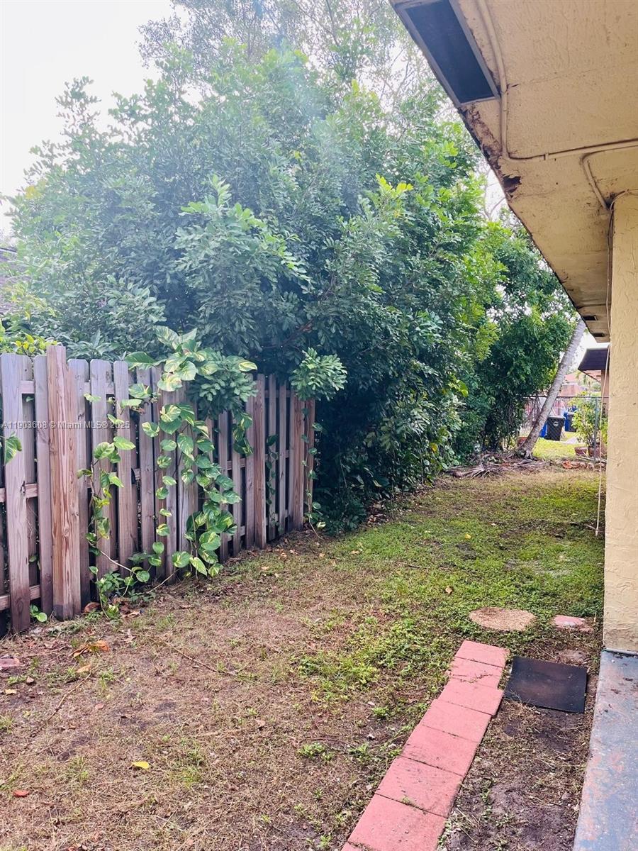 7740 Southwest 10th Street, Unit 1 North Lauderdale, FL 33068 - Photo 15 of 24 a backyard of a house with lots of green space