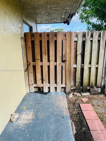 a view of a house with a wooden fence