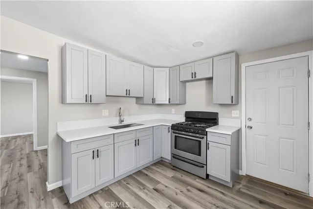 a kitchen with a sink stove and cabinets