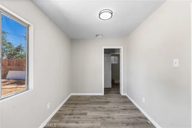 a view of hallway with wooden floor