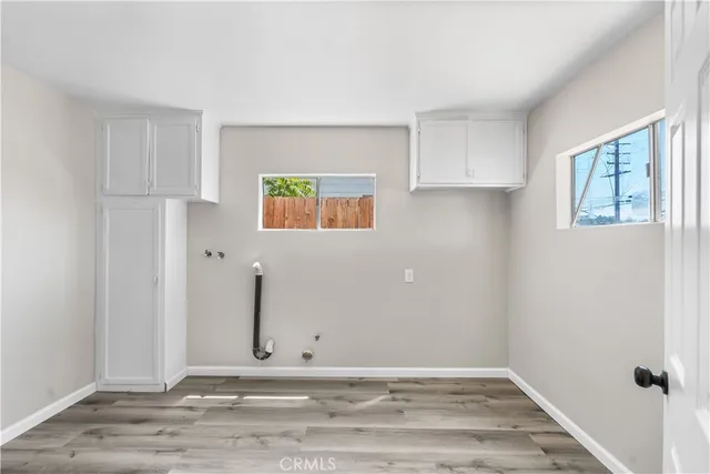 a view of an empty room with window and closet area