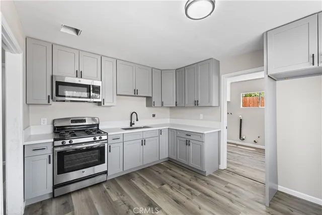 a kitchen with white cabinets and white appliances