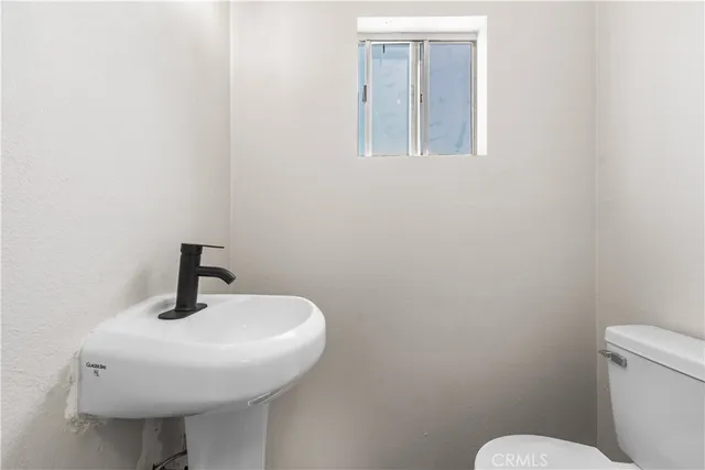 a bathroom with a sink a mirror and a toilet