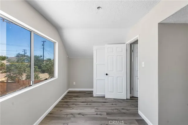 a view of a room with wooden floor and windows