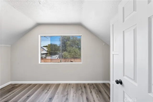 a view of a small space with wooden floor and a window