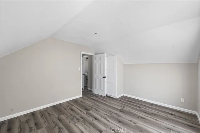 a view of room with wooden floor