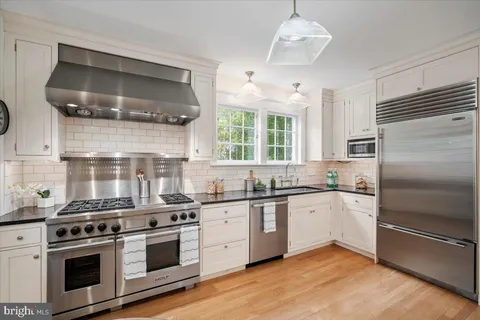a kitchen with stainless steel appliances a stove sink and refrigerator
