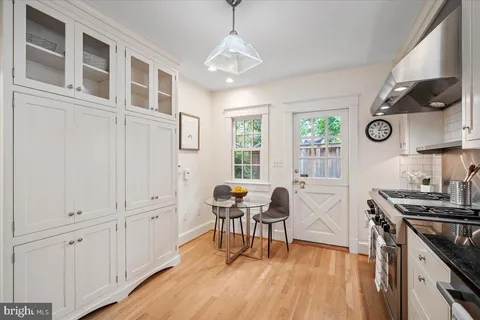 a view of a kitchen with furniture and wooden floor