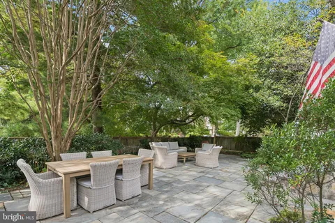 a view of a patio with table and chairs and potted plants
