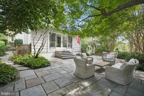 a view of a patio with table and chairs and potted plants