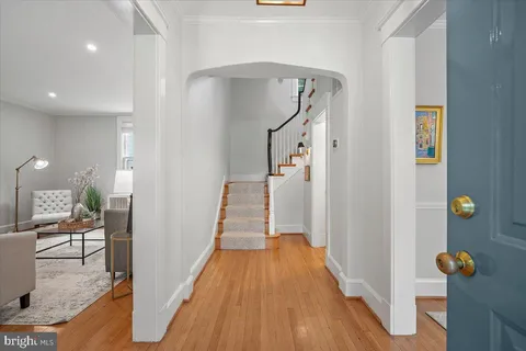 a view of a hallway view with wooden floor and living room