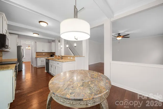 a kitchen with a refrigerator and a fireplace