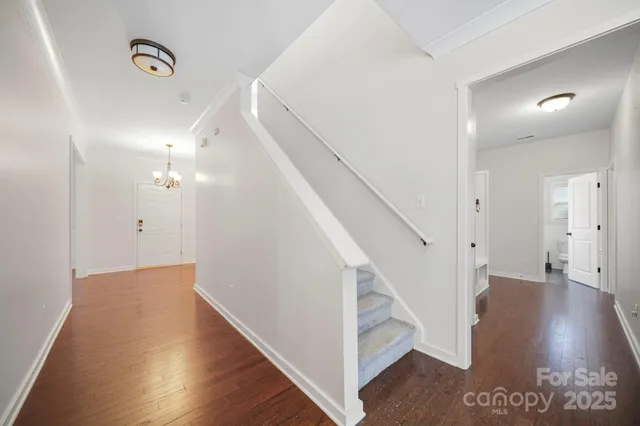 a view of entryway and hall with wooden floor