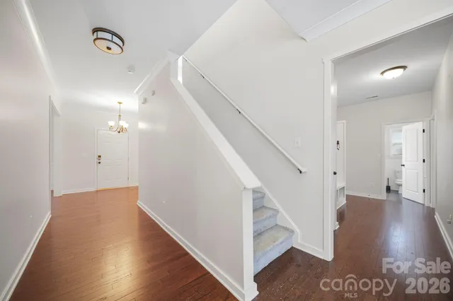 a view of entryway and hall with wooden floor