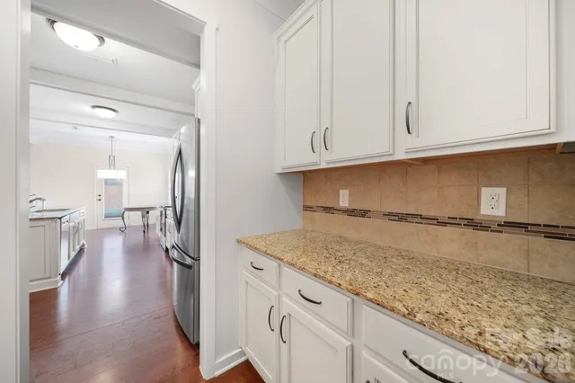a view of a kitchen with white cabinets