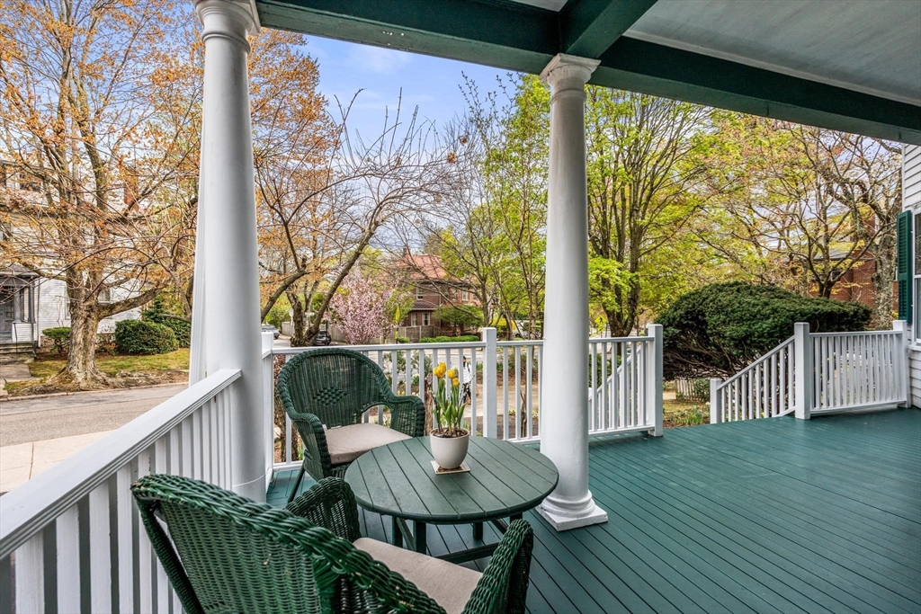 a balcony view with a large garden and outdoor seating