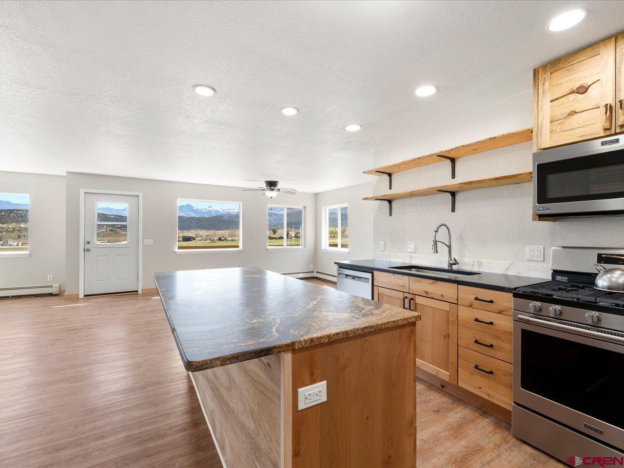 495 North Amelia Street Ridgway, CO 81432 - Photo 12 of 41 a kitchen with stainless steel appliances granite countertop a sink stove and refrigerator