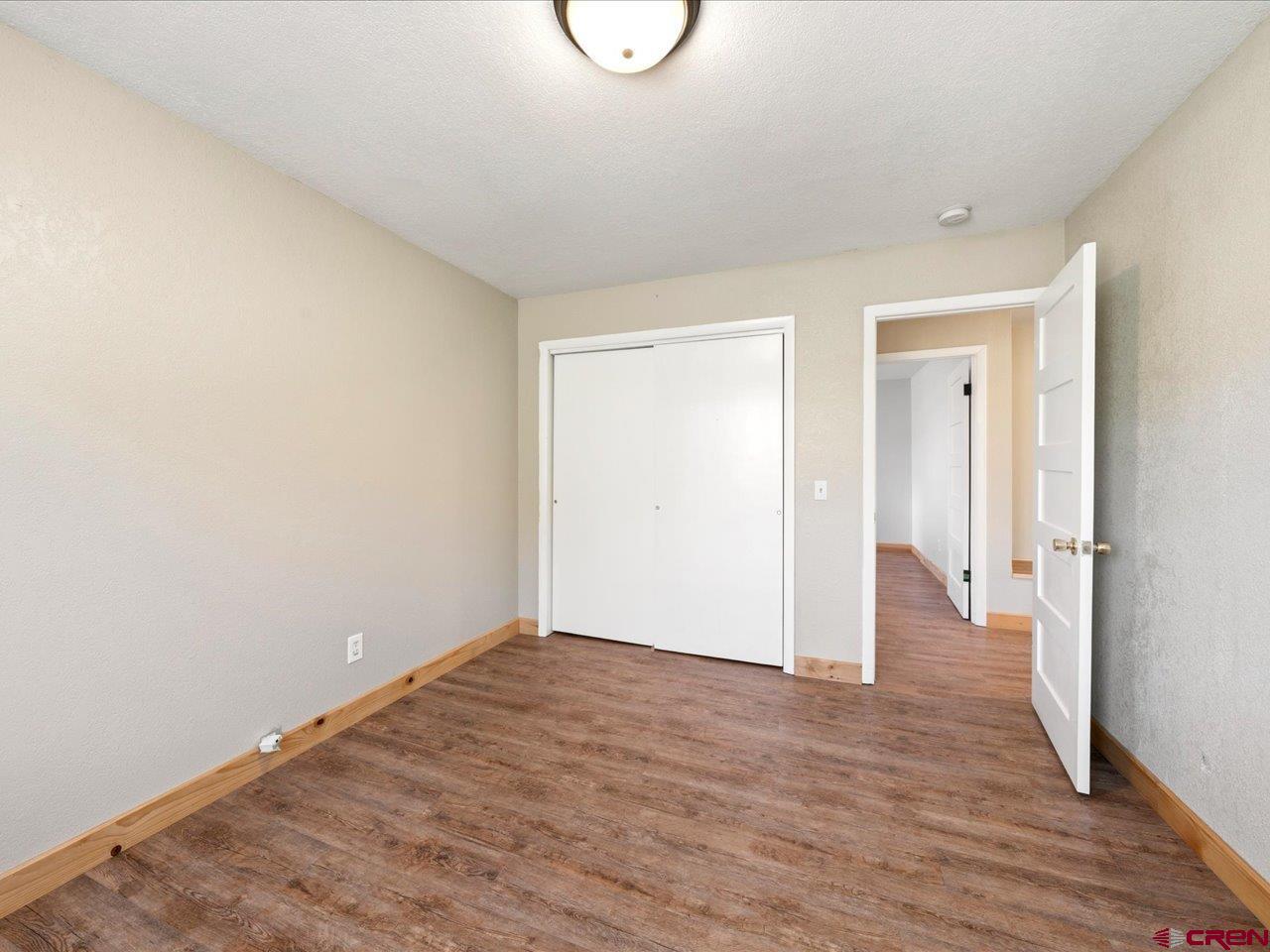 495 North Amelia Street Ridgway, CO 81432 - Photo 18 of 41 a view of an empty room with wooden floor and a window