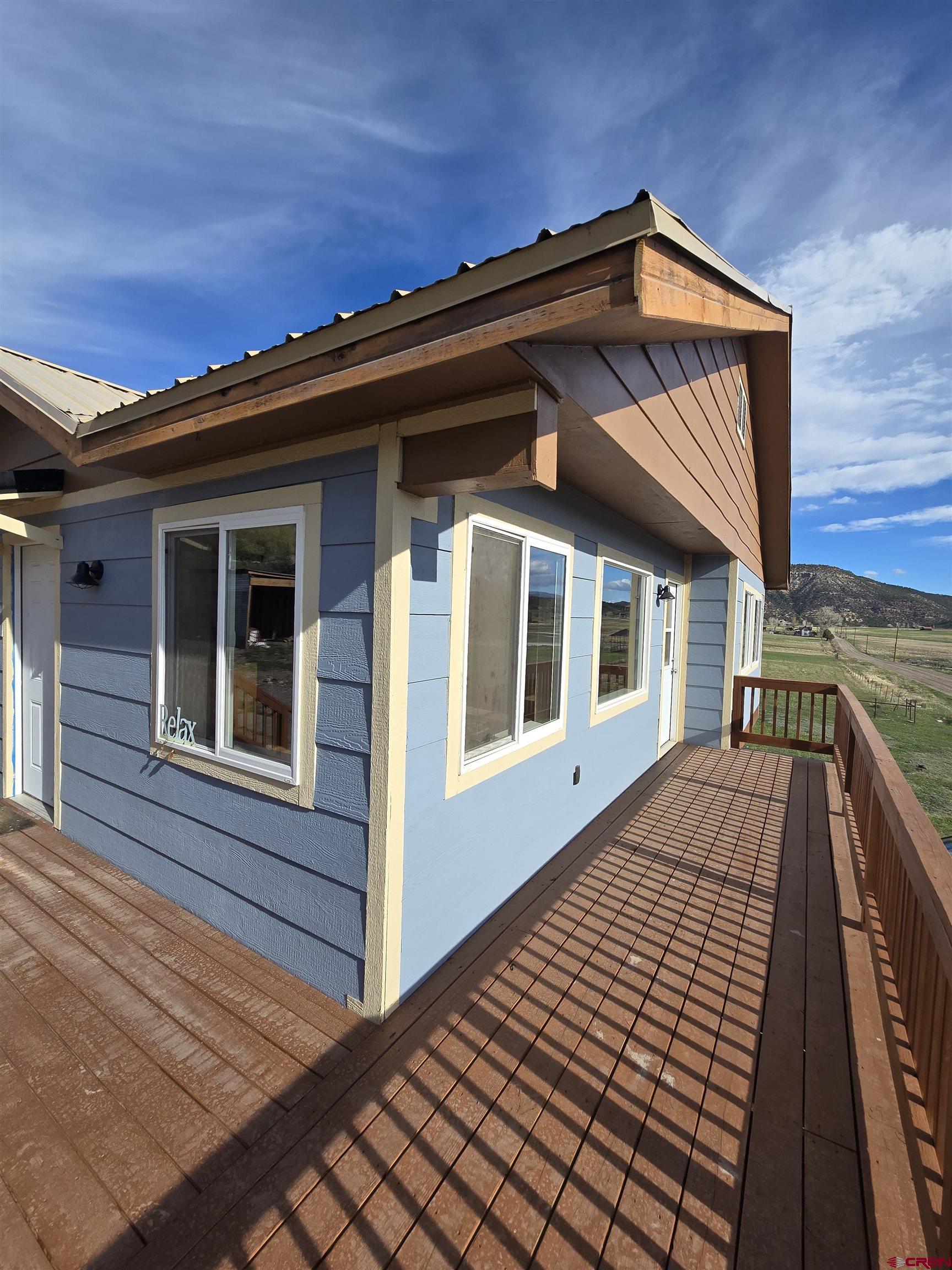 495 North Amelia Street Ridgway, CO 81432 - Photo 34 of 41 a view of a house with a roof deck