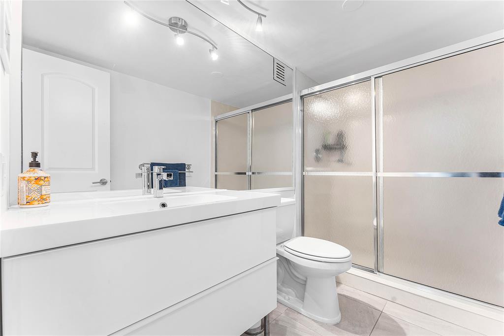 800 Southeast 20th Avenue, Unit 206 Deerfield Beach, FL 33441 - Photo 14 of 37 a bathroom with a sink a toilet and shower