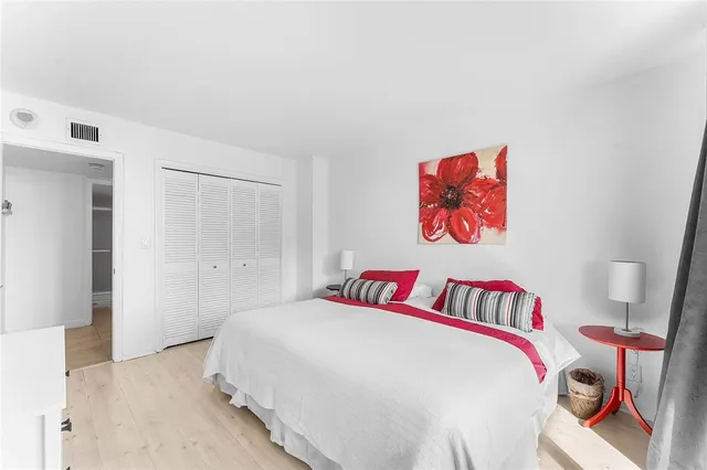 a bedroom with a bed and a book shelf