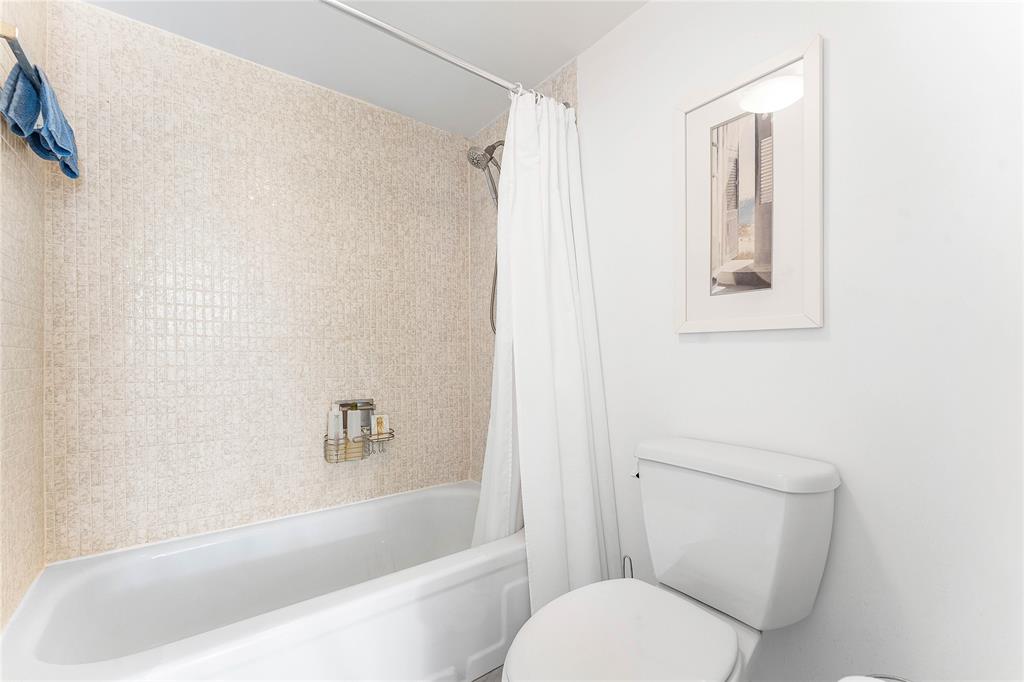 800 Southeast 20th Avenue, Unit 206 Deerfield Beach, FL 33441 - Photo 18 of 37 a white toilet sitting next to a bath tub