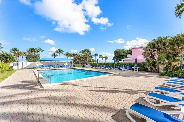 a view of a patio with swimming pool and outdoor seating