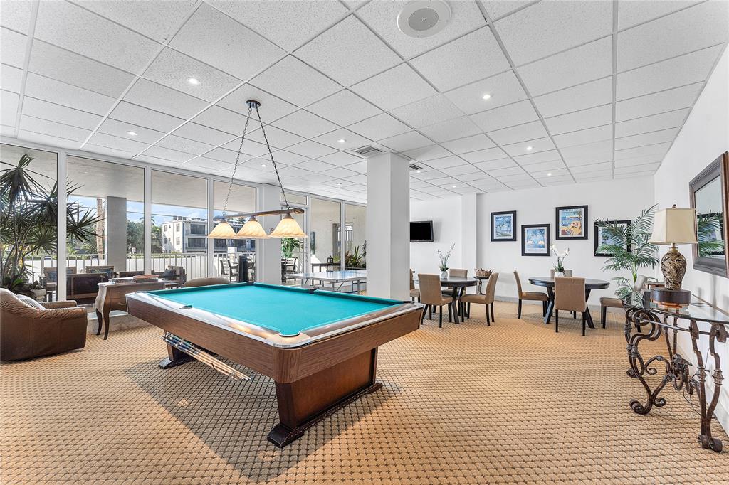800 Southeast 20th Avenue, Unit 206 Deerfield Beach, FL 33441 - Photo 25 of 37 a living room with furniture a table and chairs