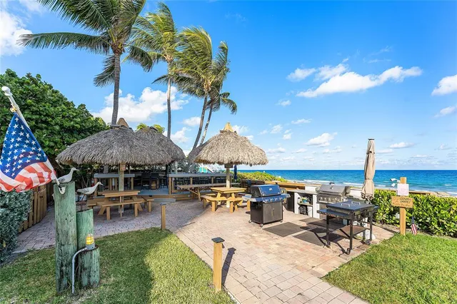 a swimming pool with outdoor seating yard and barbeque oven