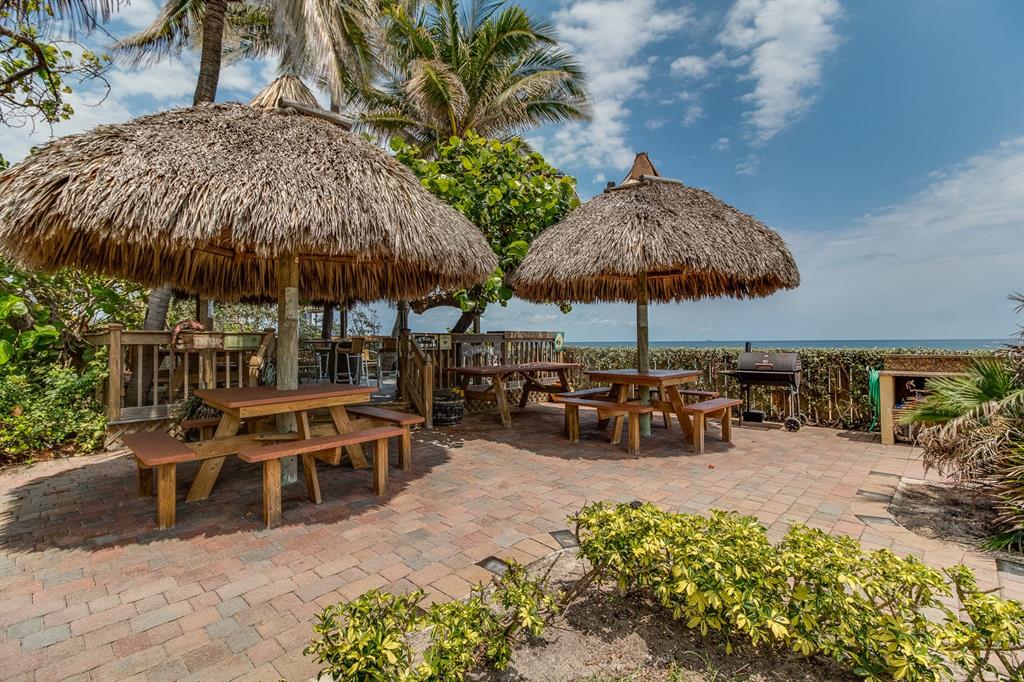 800 Southeast 20th Avenue, Unit 206 Deerfield Beach, FL 33441 - Photo 27 of 37 an outdoor space with patio and white umbrellas