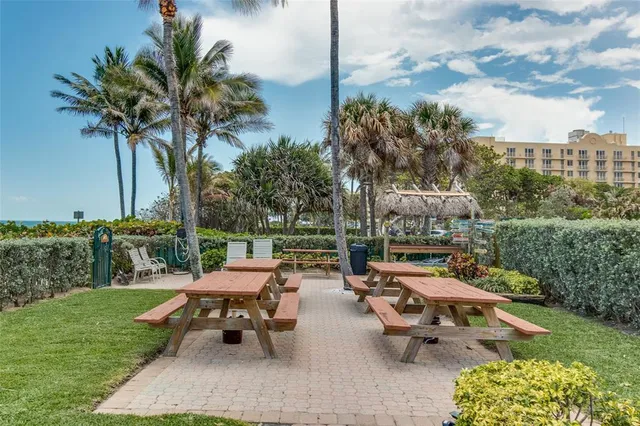 a backyard of a house with table and chairs