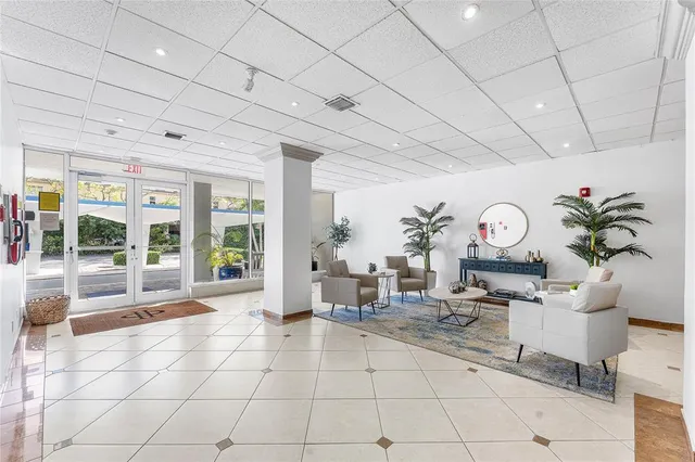 a living room with fireplace furniture and a large window