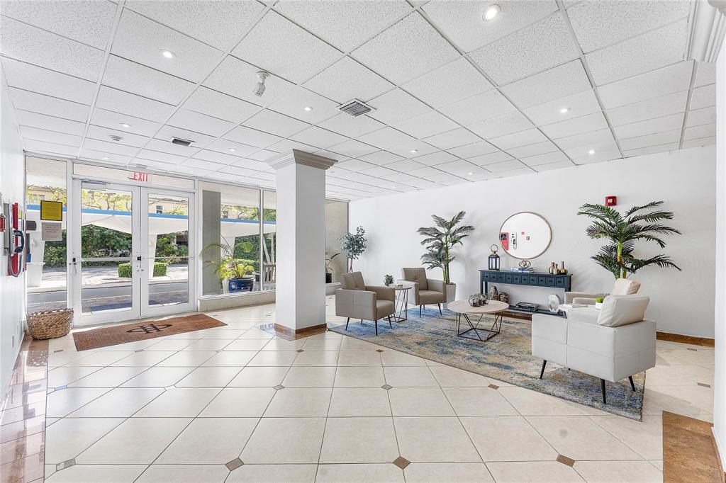 800 Southeast 20th Avenue, Unit 206 Deerfield Beach, FL 33441 - Photo 31 of 37 a living room with fireplace furniture and a large window