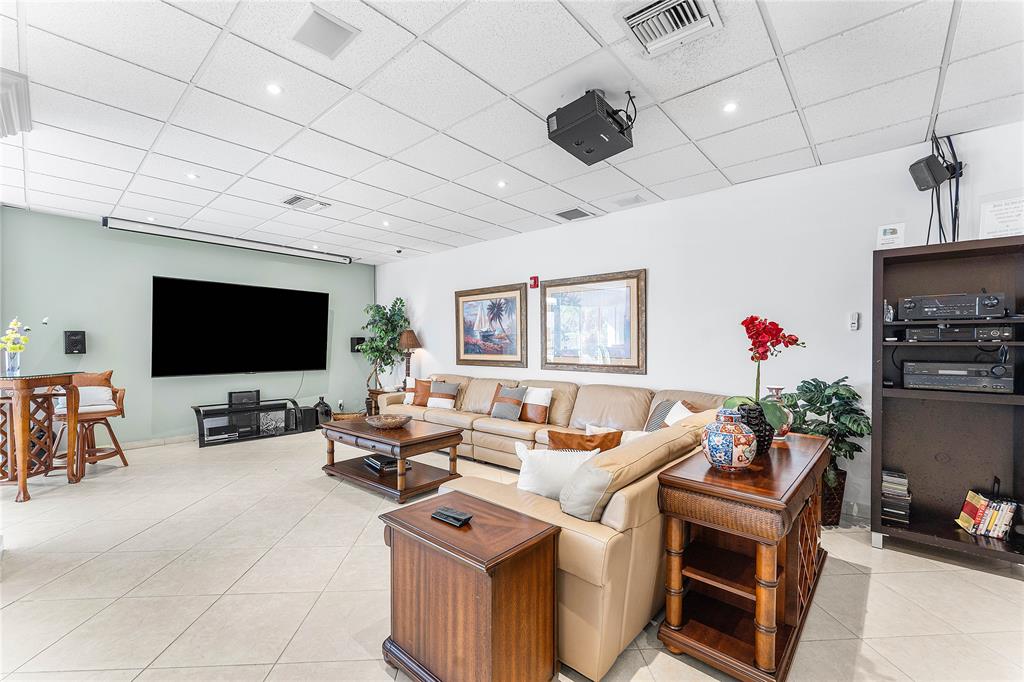 800 Southeast 20th Avenue, Unit 206 Deerfield Beach, FL 33441 - Photo 34 of 37 a living room with furniture a flat screen tv and kitchen view