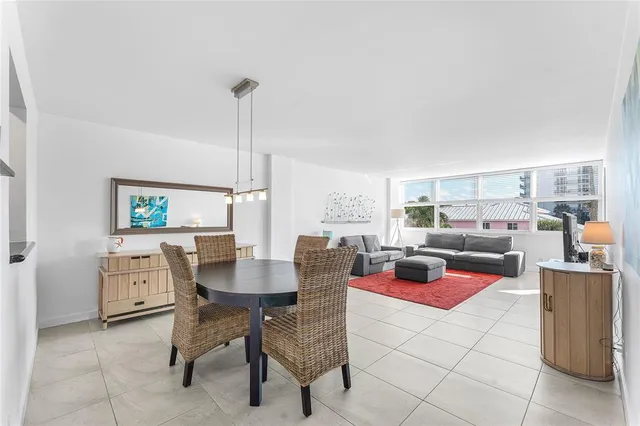 a dining room with furniture and a book shelf