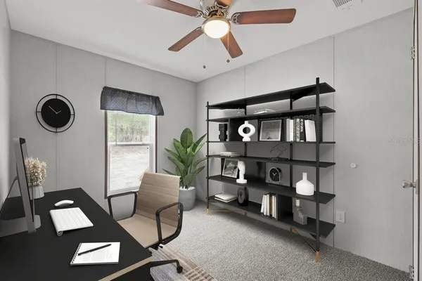 a view of a workspace with furniture and a window