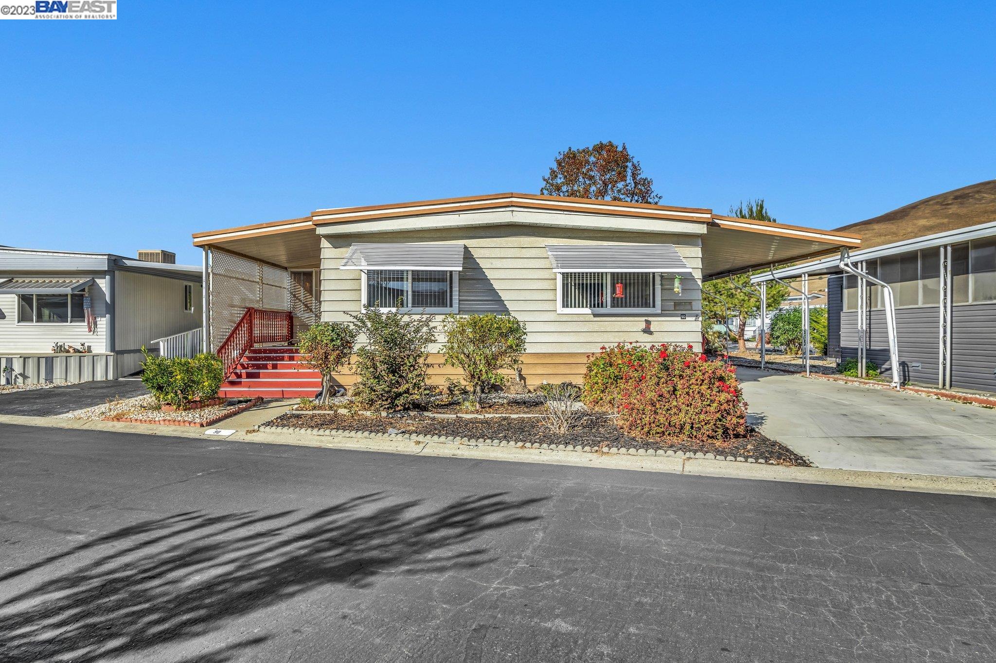711 Old Canyon Road, Unit 90 Fremont, CA 94536 - Photo 1 of 1 a front view of a house with a yard
