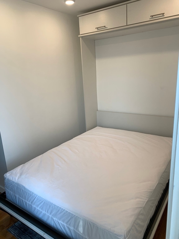 16 5th Street, Unit 23 Chelsea, MA 02150 - Photo 9 of 9 a bed sitting in a bedroom next to a window