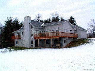 2902 East Clyde Road Howell, MI 48855 - Photo 1 of 1 Rear view of home showing fin WO